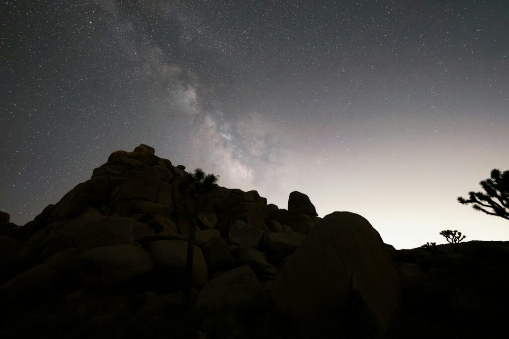 Milky way over rocky desert landscape at night